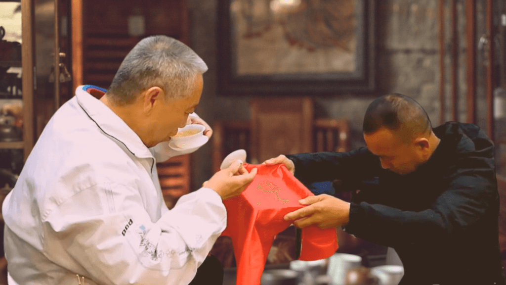 Disciple offering tea  to master in Bai Shi ceremony