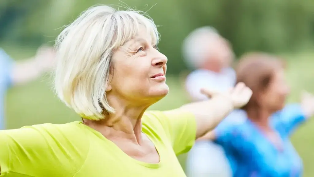 elderly woman stretching with smile