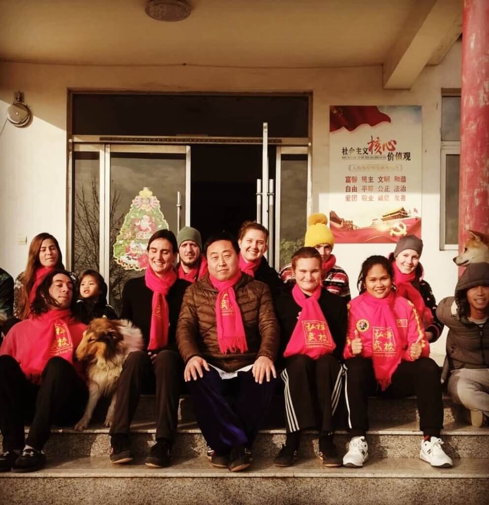 Students in Christmas scarves in front of school