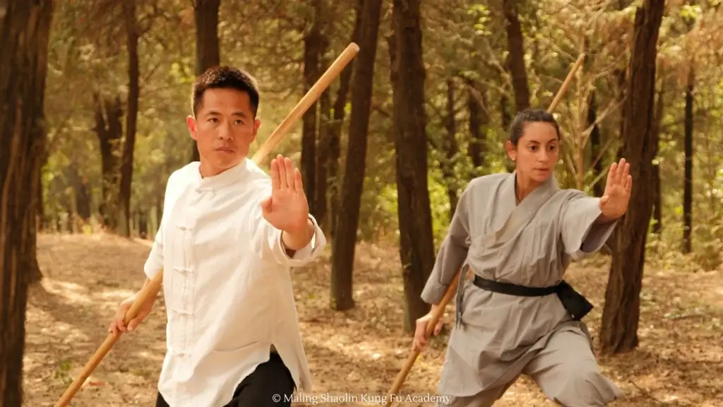 Master Bao and Student Ream training Shaolin forms and weapons (bo staff) together