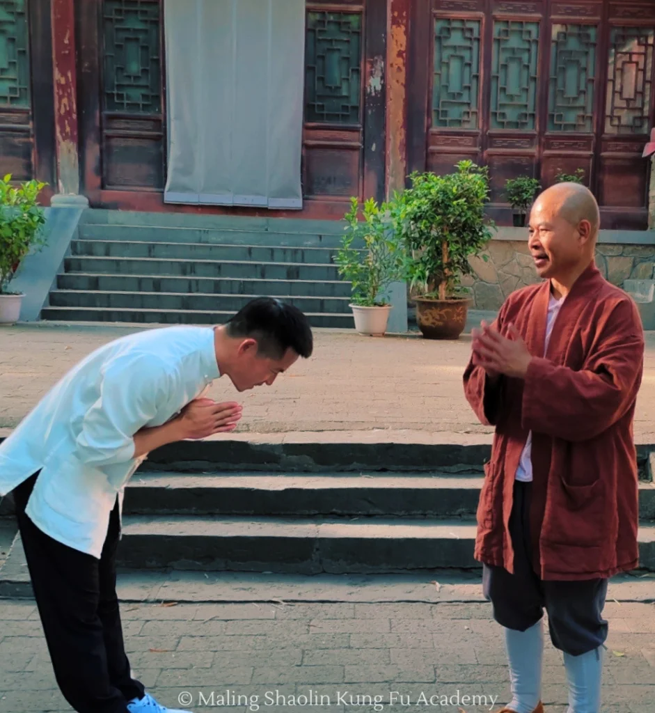 Master Bao bowing to his master Grandmaster Shi De Yang